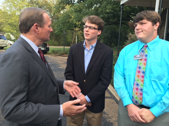 Dr. Mark Keenum, MSU president, talks with Harrison Armour and Jake Goldman at a reception held for the METP at his home.